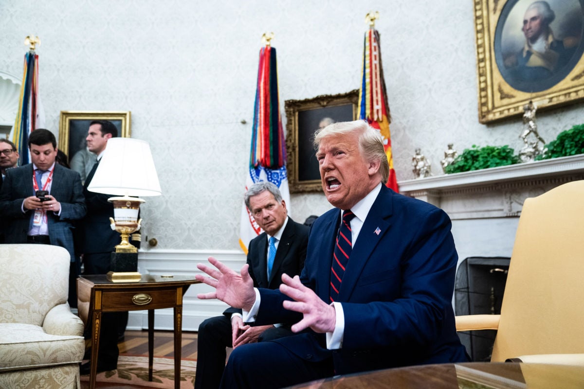 Donald Trump shouts while seated in the Oval Office