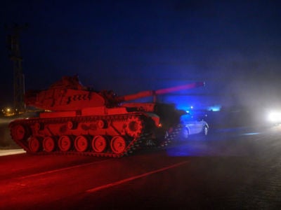 Turkish armed forces drive towards the border with Syria near Akcakale in Sanliurfa province on October 8, 2019.