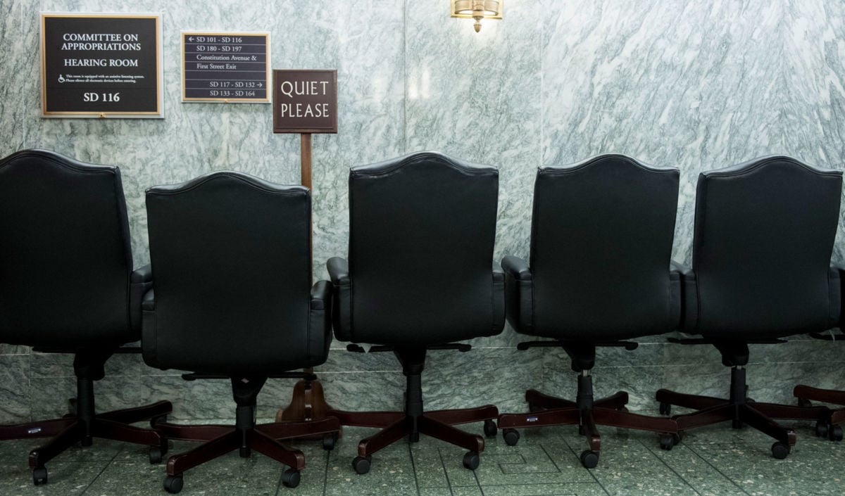 Empty chairs and a quiet please sign sit outside the Senate Committee on Appropriations hearing room in the Dirksen Senate Office Building on July 30, 2019.