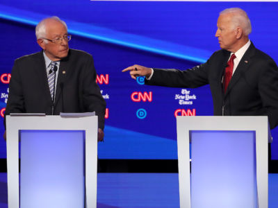 Joe Biden points a finger at Bernie Sanders on the debate stage