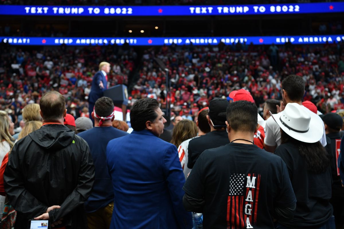 Trump supporters stand during a rally