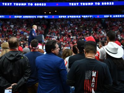 Trump supporters stand during a rally