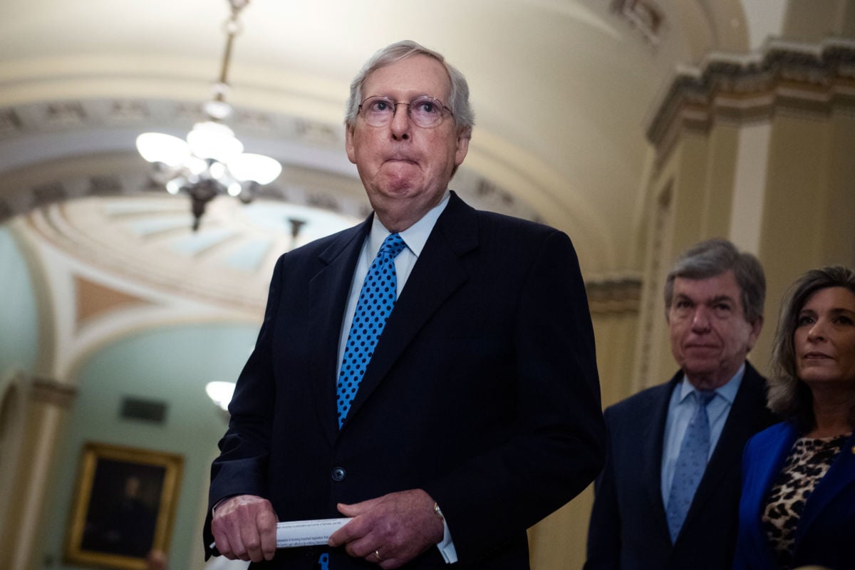 Mitch Mcconnell makes a face while preparing to make a statement