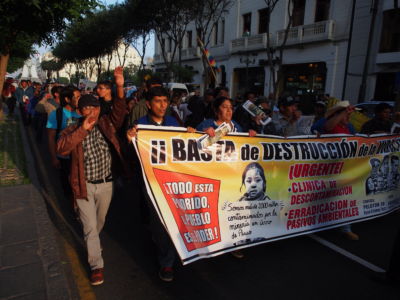 People march in the streets carrying signs during a protest