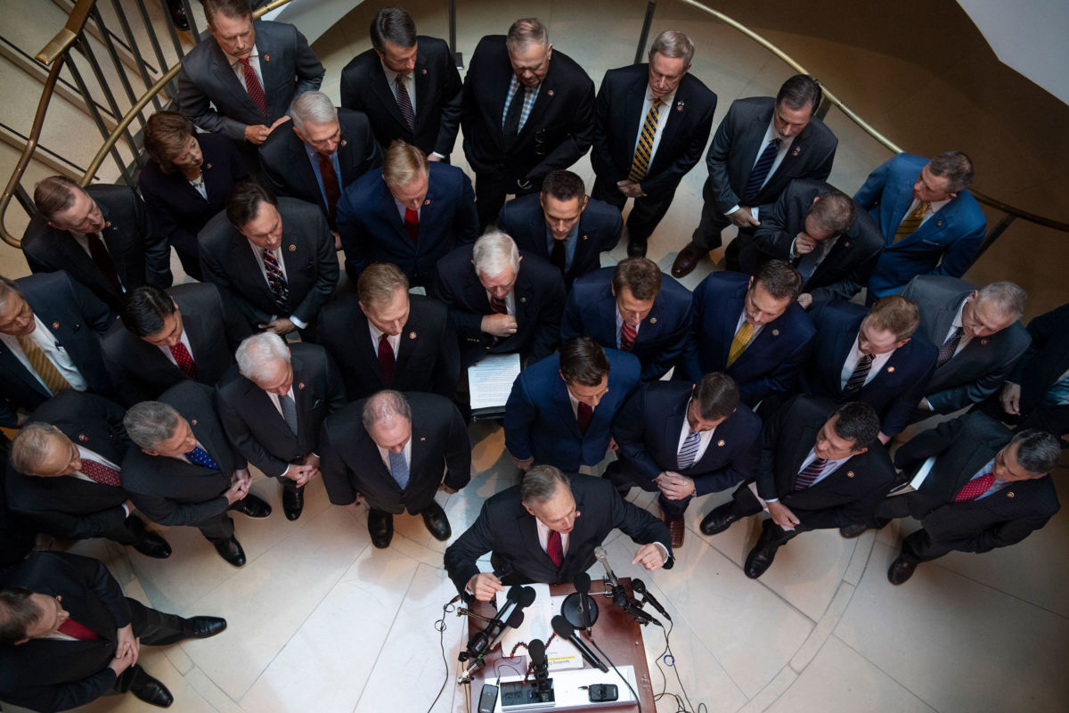 Republican Rep. Andy Biggs, at podium, speaks during a news conference in the Capitol Visitor Center outside the deposition related to the House's impeachment inquiry on October 23, 2019.