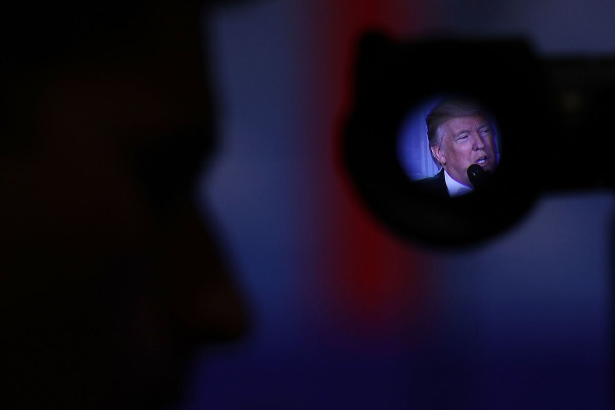 Donald Trump's face is seen through the viewfinder of a camera