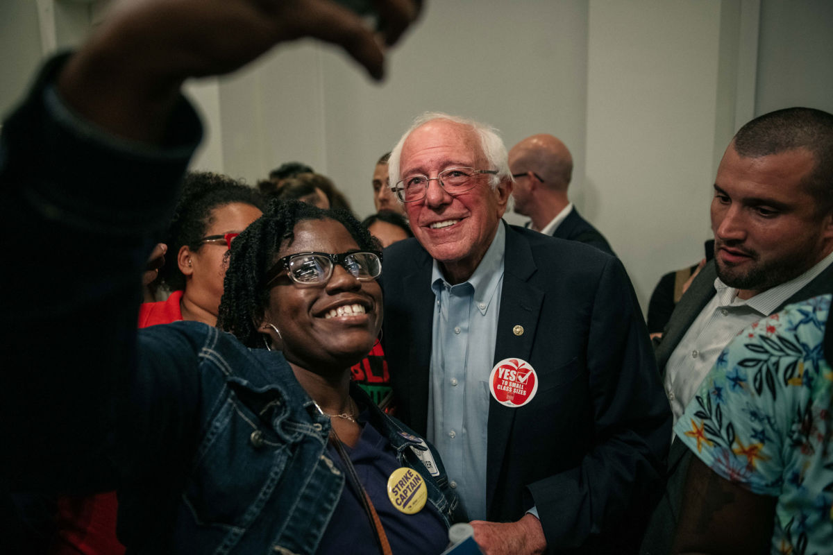 Sen. Bernie Sanders takes a selfie with a supporter at a rally in support of the Chicago Teachers Union ahead of an upcoming potential strike on September 24, 2019, in Chicago.