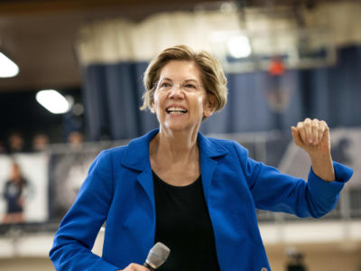 Sen. Elizabeth Warren smiles as she takes the stage during a campaign rally