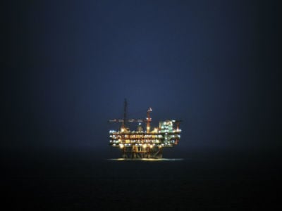 An oil rig stands in the ocean