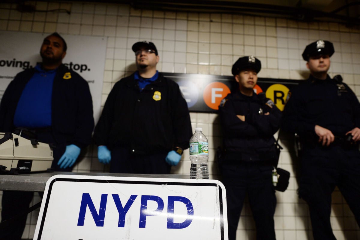 New York Police Department officers at a checkpoint at the entrance to a subway station in Queens, New York, on October 24, 2014.