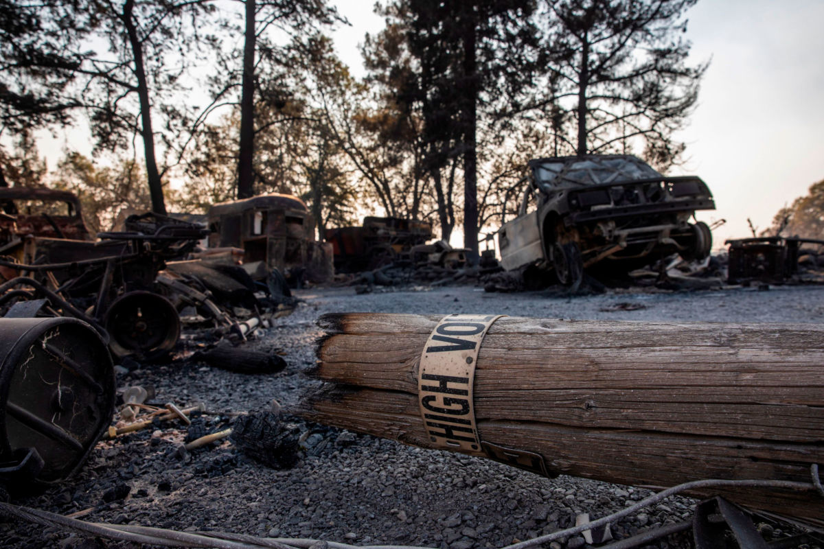 A fallen PG&E utility pole lays on a property burned during the Kincade Fire along Highway 128 in Healdsburg, California, on October 28, 2019.