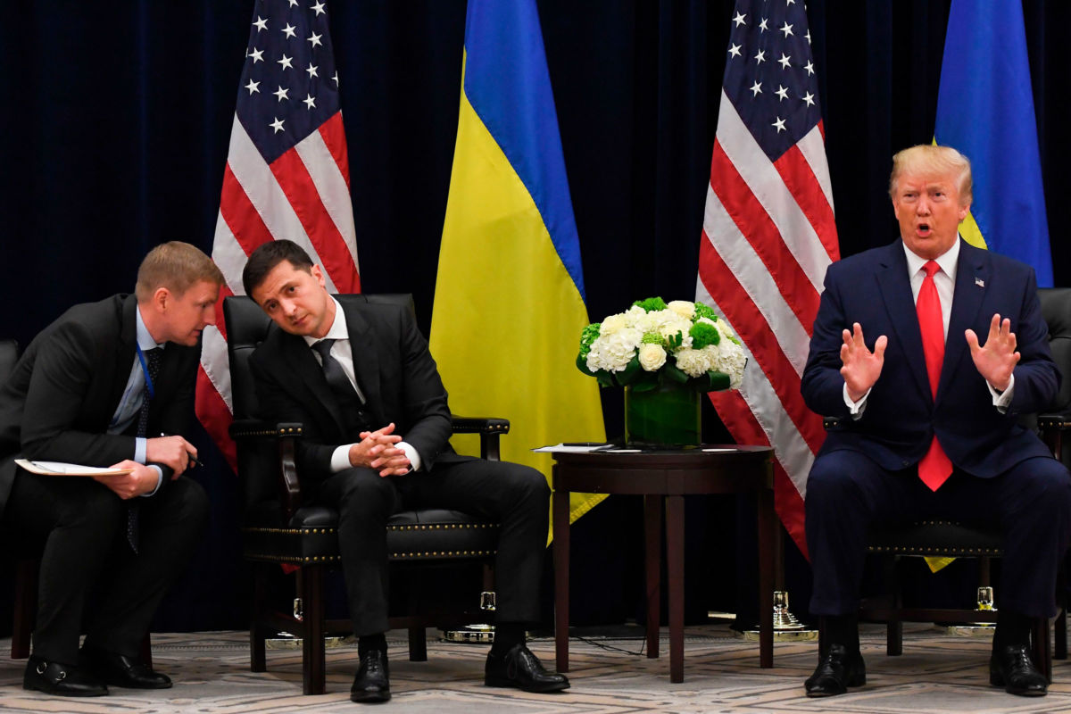 President Trump speaks as Ukrainian President Volodymyr Zelensky speaks with an aide during a meeting in New York on September 25, 2019, on the sidelines of the United Nations General Assembly.