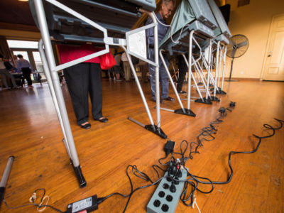 People use electronic voting machines to cast their ballot in the midterm elections at Neighborhood Congregational Church in Laguna Beach, California, on November 6, 2018.