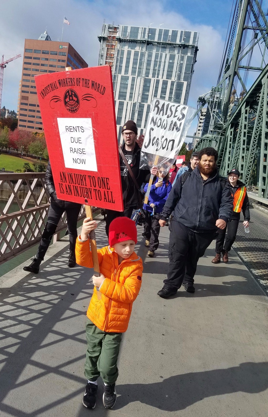 Burgerville Workers Union members and their supporters march across the Willamette River to the Hawthorne Burgerville location to announce their strike.