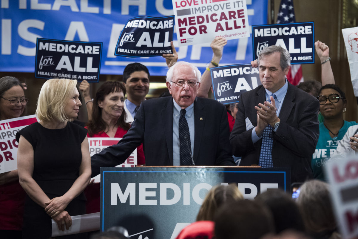 From left, Sens. Kirsten Gillibrand, D-N.Y., Bernie Sanders, I-Vt., and Jeff Merkley, D-Ore., conduct an event to introduce the "Medicare for All Act of 2019" in Dirksen Building on Wednesday, April 10, 2019.