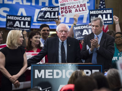 From left, Sens. Kirsten Gillibrand, D-N.Y., Bernie Sanders, I-Vt., and Jeff Merkley, D-Ore., conduct an event to introduce the "Medicare for All Act of 2019" in Dirksen Building on Wednesday, April 10, 2019.