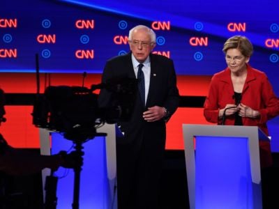 Sens. Elizabeth Warren and Bernie Sanders during a break in the Democratic primary debate