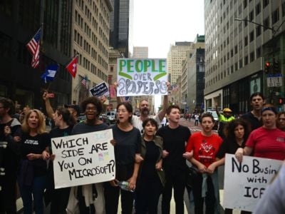 Protestors hold posters as they block a street in midtown Manhattan during a rally against U.S. immigration policy on September 14, 2019, in New York City.