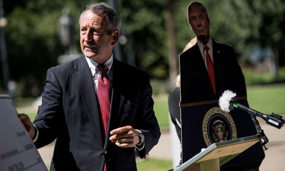 Former South Carolina Gov. Mark Sanford speaks to the media with a cardboard cutout of President Trump during a campaign stop at the state house on September 16, 2019, in Columbia, South Carolina.