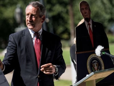 Former South Carolina Gov. Mark Sanford speaks to the media with a cardboard cutout of President Trump during a campaign stop at the state house on September 16, 2019, in Columbia, South Carolina.