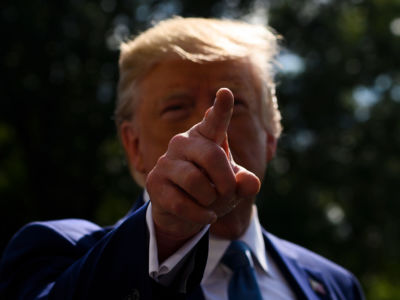 President Trump gestures at reporters as he departs the White House for Walter Reed hospital on the South Lawn on October 4, 2019.