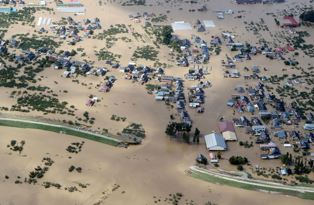 This aerial view shows flooded homes beside the collapsed bank of the Chikuma river in Nagano on October 13, 2019, one day after Typhoon Hagibis swept through central and eastern Japan.