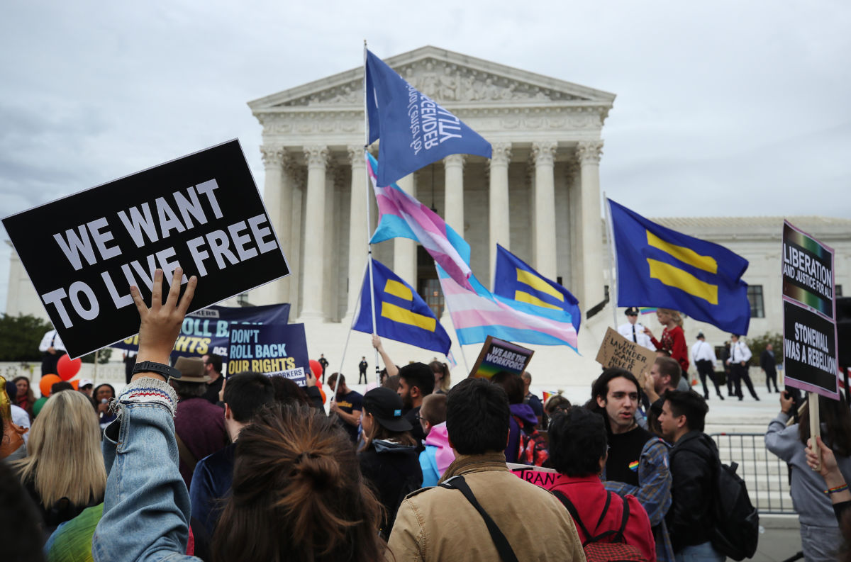 Protesters rally in front of the U.S. Supreme Court as arguments are heard in a set of cases concerning the rights of LGBTQ people in the workforce on October 8, 2019, in Washington, D.C.