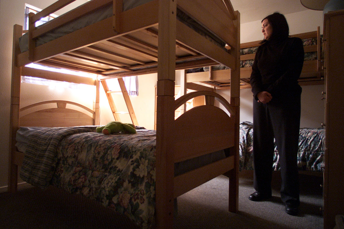 Summer Loree, shelter manager for The Coalition to end Domestic and Sexual Violence, stands in one of the bedrooms crammed full of bunk beds in the Ventura area shelter.