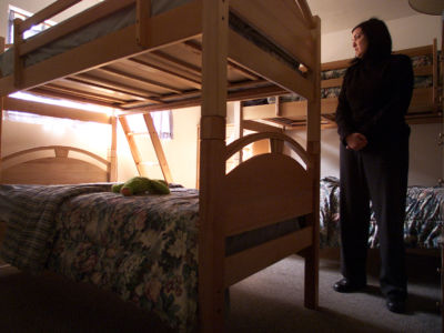 Summer Loree, shelter manager for The Coalition to end Domestic and Sexual Violence, stands in one of the bedrooms crammed full of bunk beds in the Ventura area shelter.