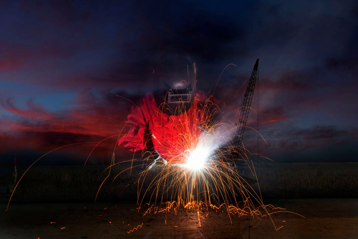 Double exposure of Industrial Worker and silhouette construction site sunset