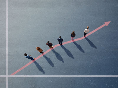 Businesspeople standing on painted upward graph on asphalt