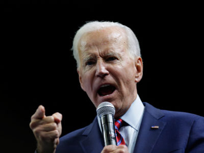 Joe Biden points while speaking into a microphone