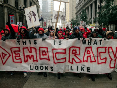 Braving snow and cold temperatures, thousands marched through the streets near City Hall during the 11th day of the teacher strike on October 31, 2019, in Chicago, Illinois.