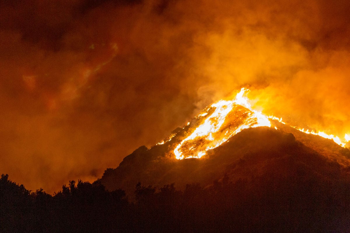 A mountain in the distance is on fire