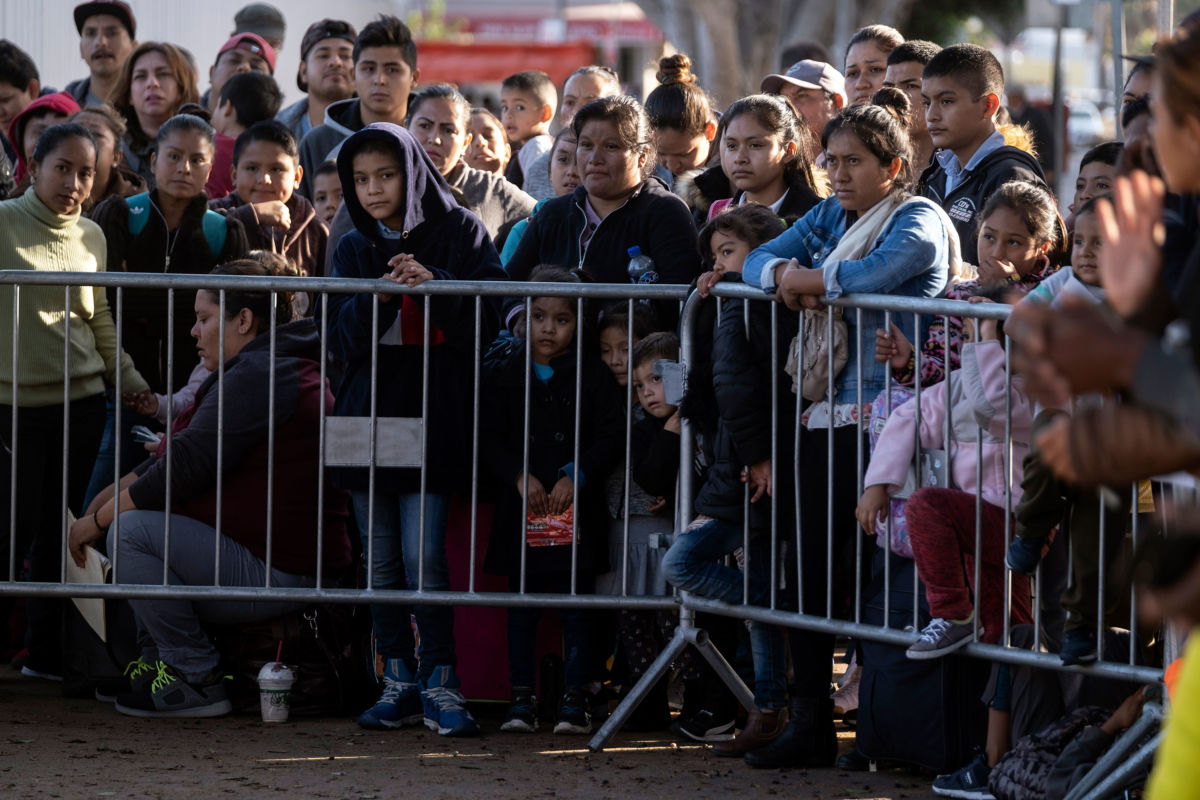 Asylum seekers gather as they look for an appointment date with U.S. authorities outside El Chaparral crossing port on the U.S.-Mexico border in Tijuana, Baja California state, Mexico, on October 18, 2019.