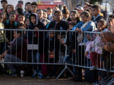 Asylum seekers gather as they look for an appointment date with U.S. authorities outside El Chaparral crossing port on the U.S.-Mexico border in Tijuana, Baja California state, Mexico, on October 18, 2019.