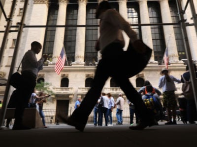 People walk by the New York Stock Exchange on October 1, 2019, in New York City.