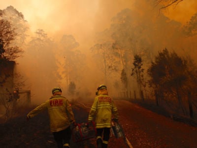 Firefighters try to save houses from an encroaching bushfire at Lakes Way in Australia