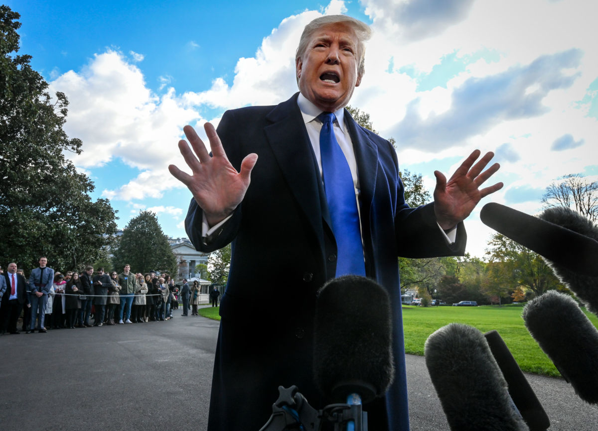 President Trump talks to reporters before he departs the White House