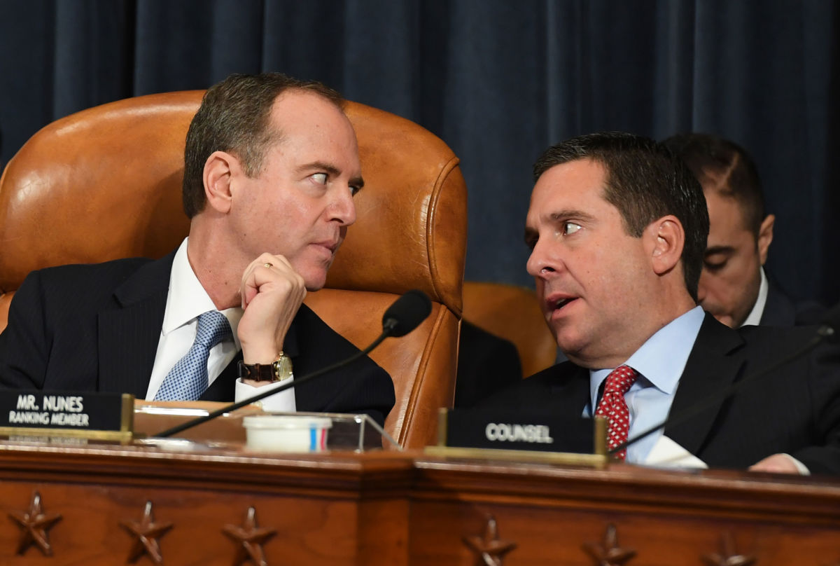 House Intelligence Committee Chair Adam Schiff, left, talks with Rep. Devin Nunes during an impeachment hearing