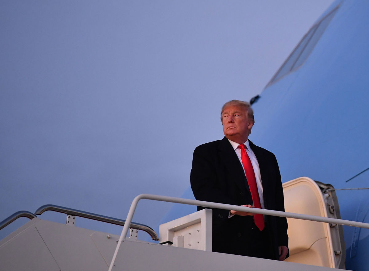 Donald Trump stands at the entrance to Air Force One