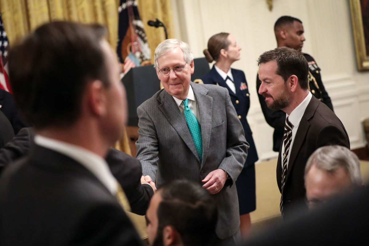 Senate Majority Leader Mitch McConnell mingles with guest