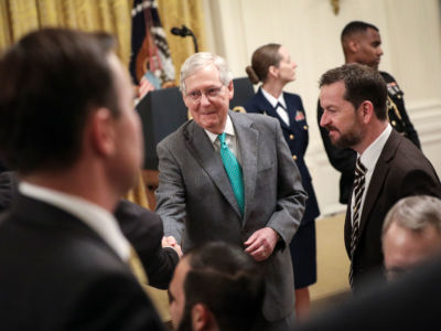 Senate Majority Leader Mitch McConnell mingles with guest