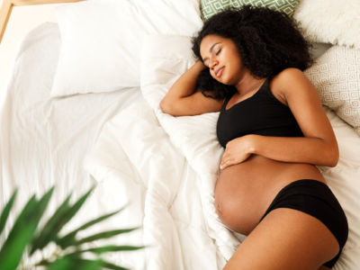 A pregnant woman relaxes in bed