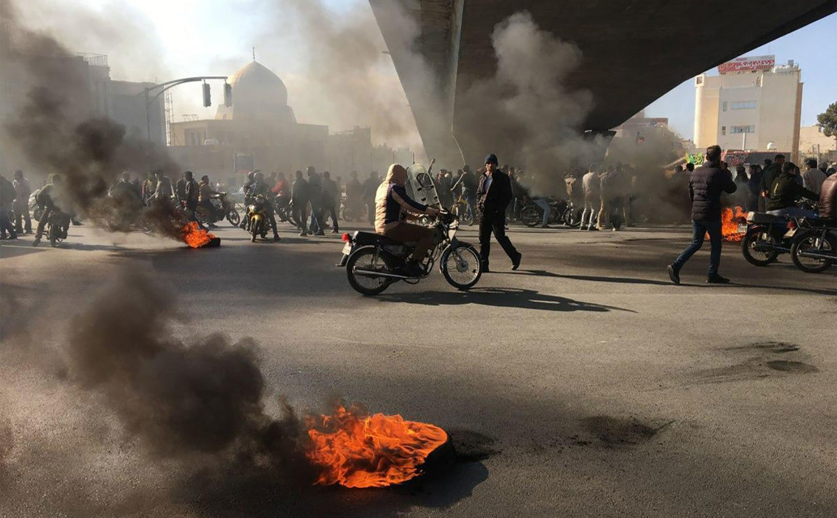 Iranian protesters rally amid burning tires during a demonstration against an increase in gasoline prices, in the central city of Isfahan on November 16, 2019.
