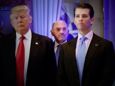 Donald Trump and Donald Junior stand in front of Allen Weisselberg