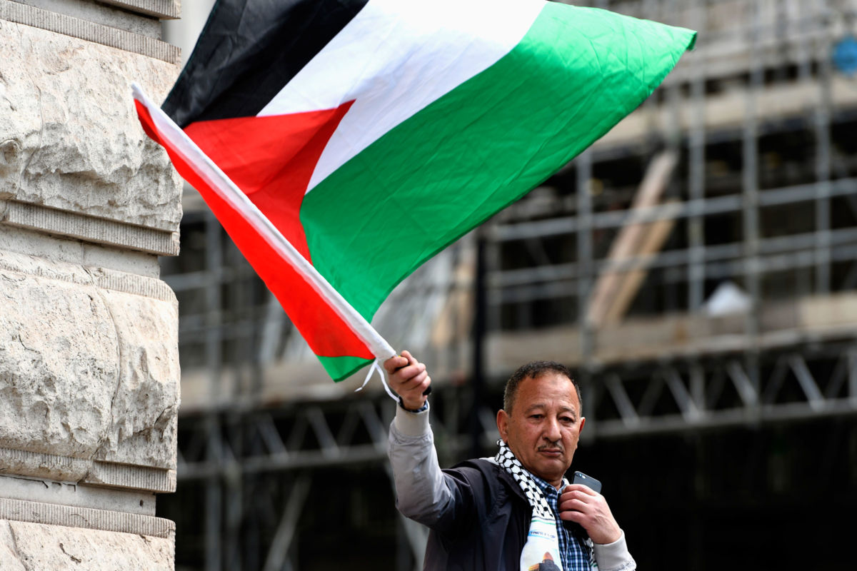 A protester waves the Palestinian flag