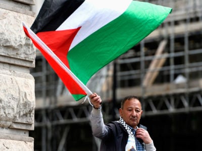 A protester waves the Palestinian flag