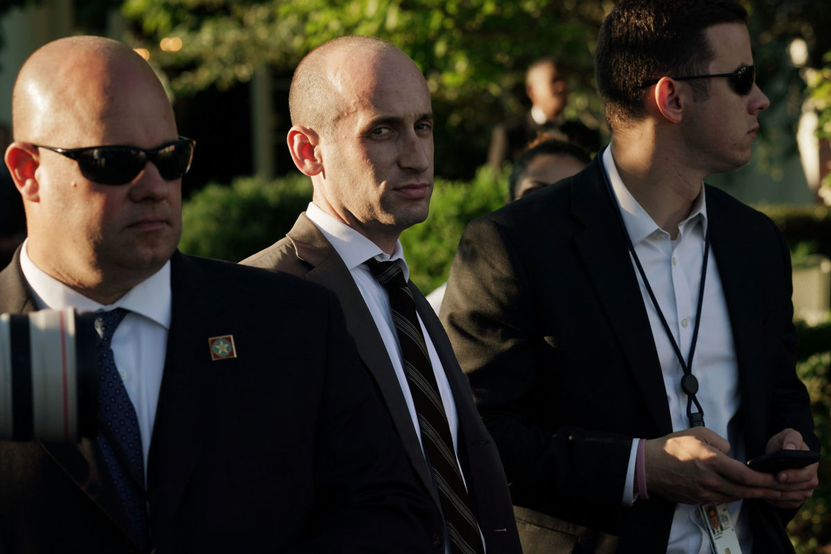 Stephen Miller is flanked by two gaurds