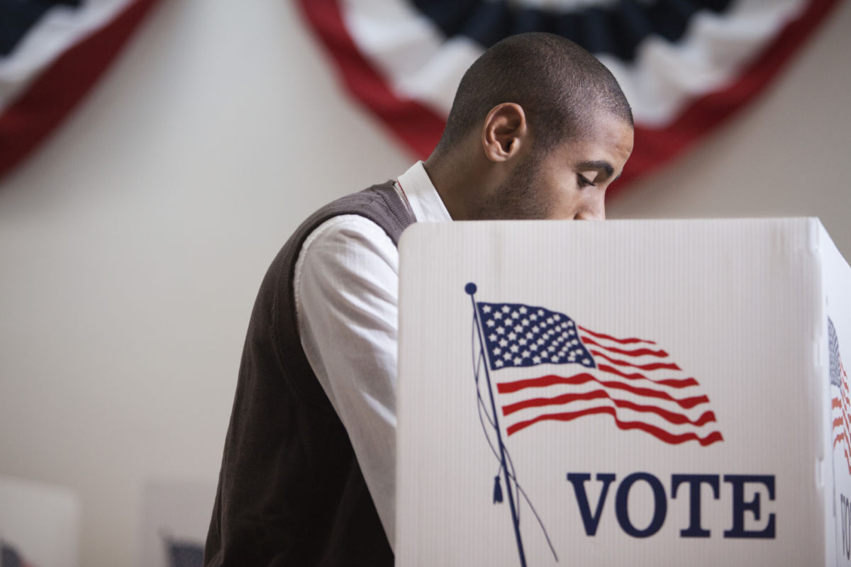 A voter stands at a booth